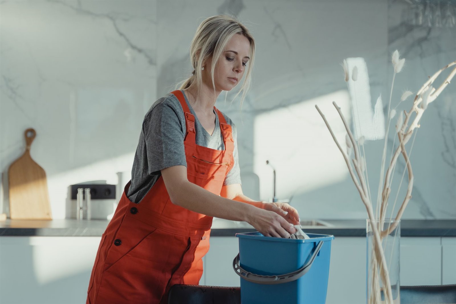 Cleaner preparing an apartment kitchen counter for guest arrival