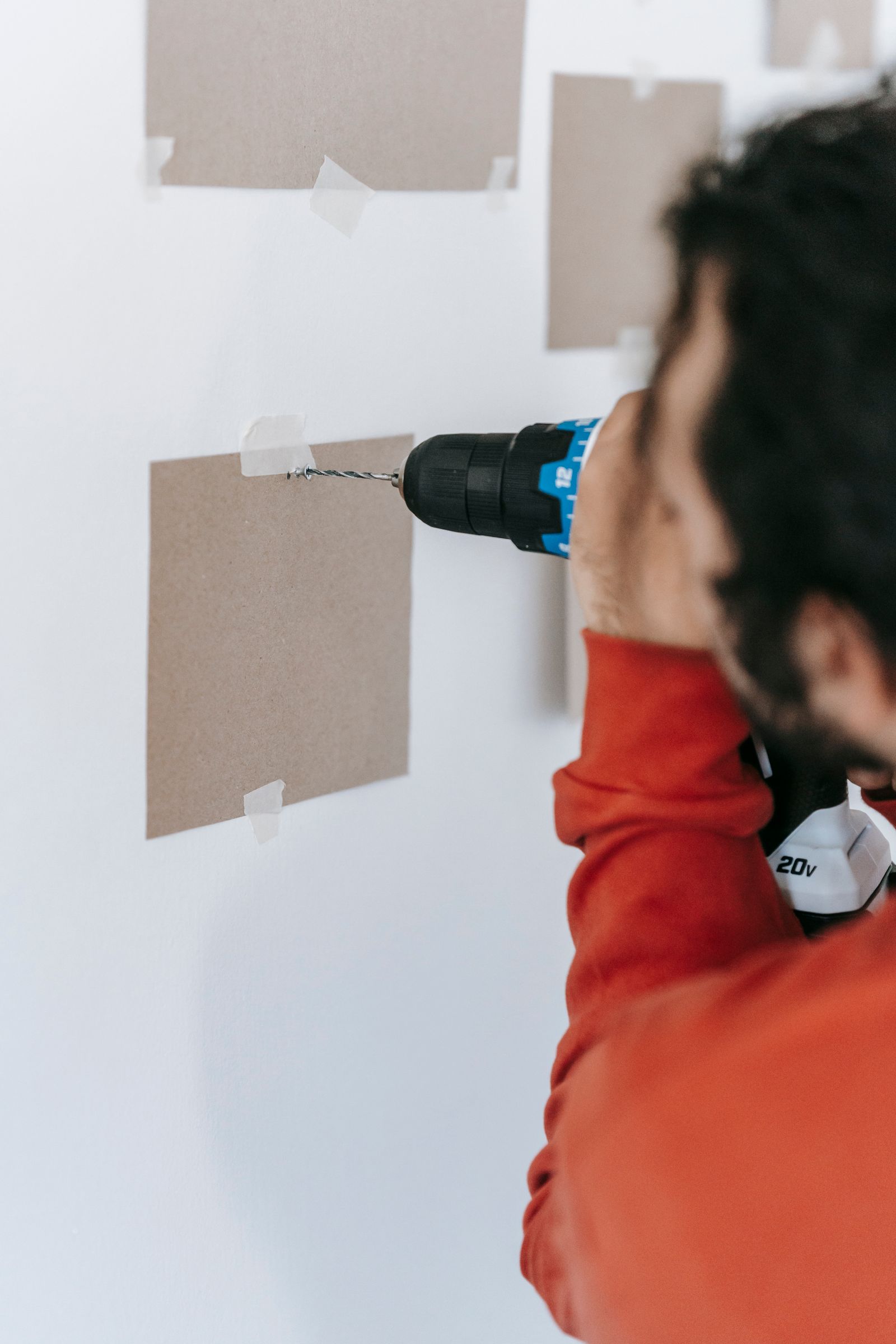 Handyman drilling a wall for a small apartment repair in Budapest