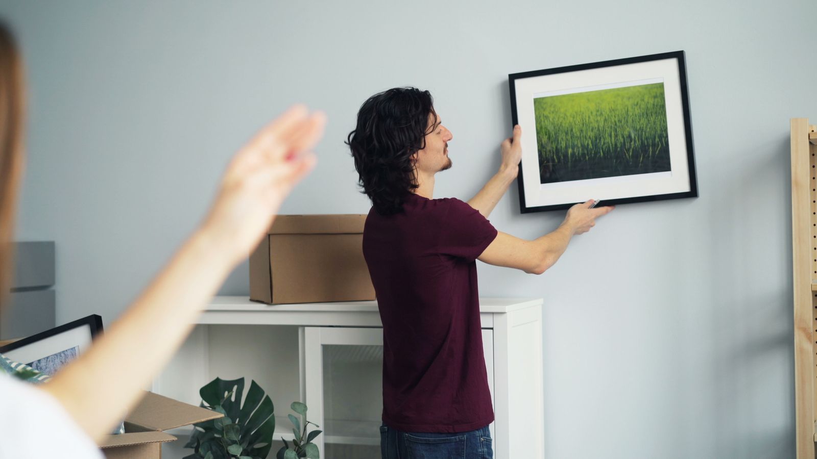 Illustrative example of fitting a picture frame on an apartment wall